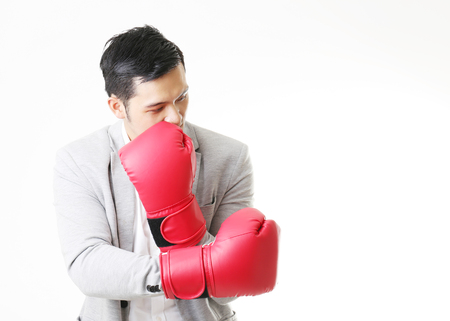 Portrait of Asian Man with boxing gloves in Isolated Backgroundの写真素材