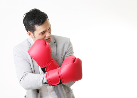 Portrait of Asian Man with boxing gloves in Isolated Backgroundの写真素材