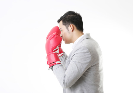 Portrait of Asian Man with boxing gloves in Isolated Backgroundの写真素材