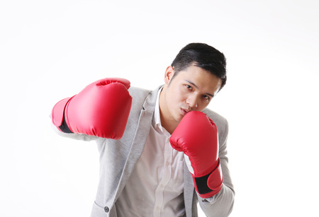 Portrait of Asian Man with boxing gloves in Isolated Backgroundの写真素材
