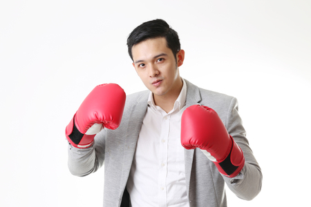 Portrait of Asian Man with boxing gloves in Isolated Backgroundの写真素材