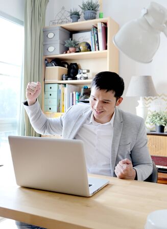 Young asian businessman working with laptop in home officeの写真素材