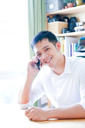 A Portrait of young asian man working with laptop  and showing gesture signの写真素材