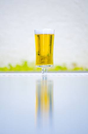 a glass of cold beer near poolの写真素材