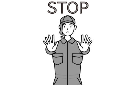 A mechanic woman in coveralls with her hands out in front of her body, signaling a stop, Vector Illustrationのイラスト素材