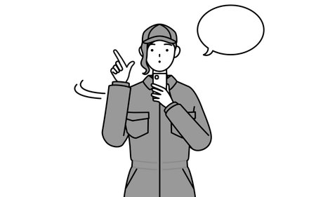 A mechanic woman in coveralls operating a smartphone, Vector Illustrationのイラスト素材