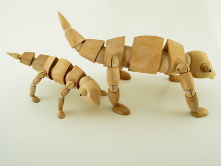 two wooden, jointed chameleons pose sideの写真素材