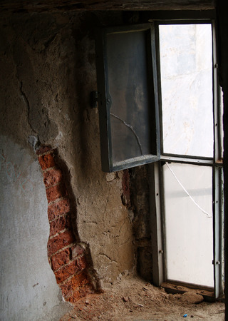  Old window behind red bricks of the wallの写真素材