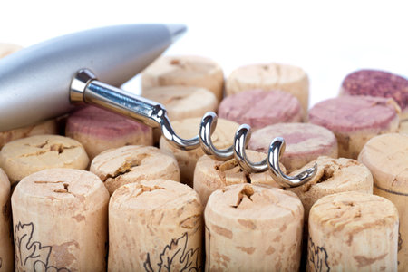 Noble metal corkscrew lies on many corks