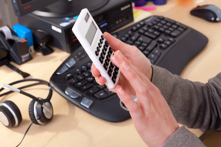 Female hand keeps a calculator in their hand