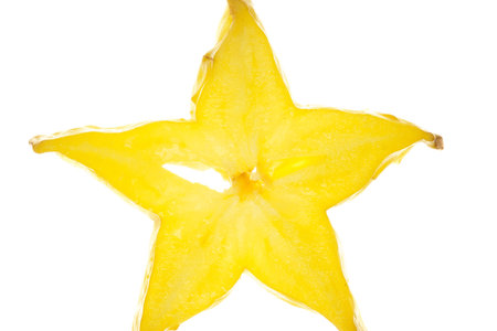 Macro shot of a carambola slice on white backgroundの写真素材