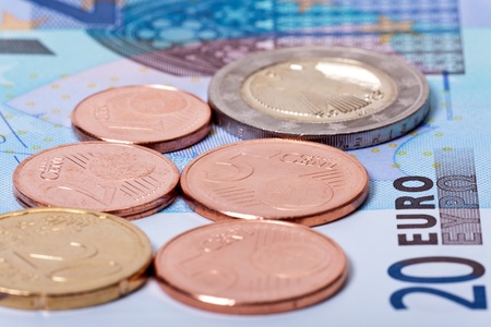 Shiny euro coins and banknotes as close up viewの写真素材