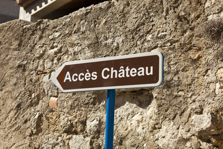 Signpost to the Chateau    in front of a medieval wall in Gruissan, southern Franceの写真素材