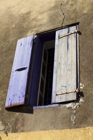 Window with shutters on a medieval house in Gruissan, Southern Franceの写真素材