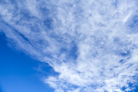 Bright blue sky with good weather cloudsの写真素材