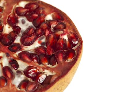 Extreme macro shot of a halved pomegranate isolated against white backgroundの写真素材