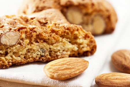 Cantuccini biscuits and almond kernels as closeup on a tablecloth lyingの写真素材