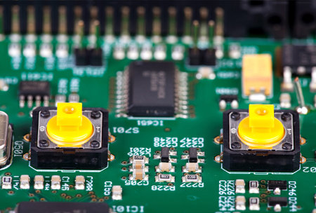 Two Yellow buttons Soldered into to a circuit boardの写真素材