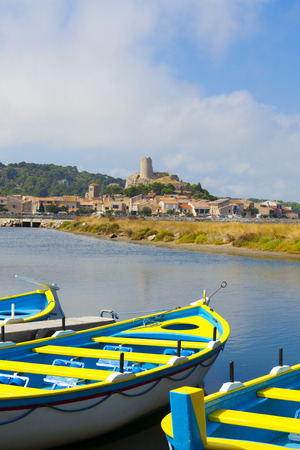 View of the medieval village Gruissan with colorful rowing boats in the foregroundの写真素材