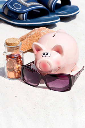 Piggy bank and beach accessories, saving for the the holidayの写真素材