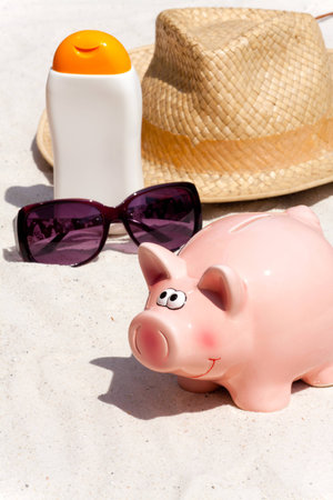 Piggy bank and beach accessories, saving for the next holidayの写真素材