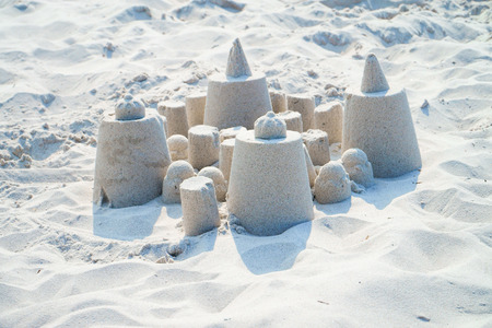 Small sand castle on the sunny beachの写真素材