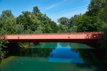 Bridge over Rhine side canal with turquoise waters and beautiful landscapeの写真素材