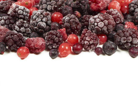 Many mixed frozen berry fruits on white background with copy spaceの写真素材