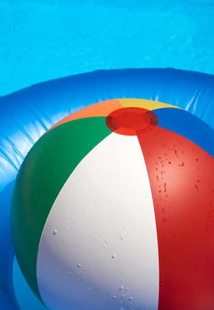 Water fun with a Floating tire and Beach Ball in the paddling poolの写真素材