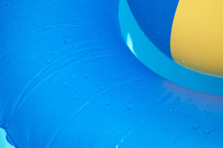 Floating tire and Beach Ball in the paddling poolの写真素材
