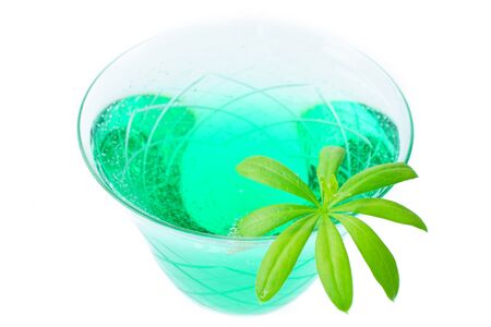 Close up woodruff punch with woodruff leaf isolated front of white backgroundの写真素材