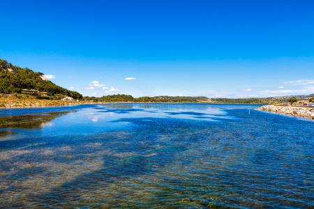 Wide water inlet to the Mediterranean from the Ãtang de Gruissan pond at the small French village of Gruissan in southern Franceの写真素材