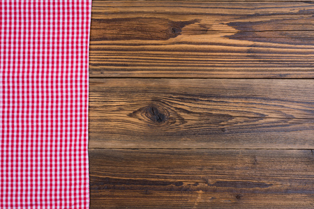Rustic old wood background with red white checkered cloth with copy