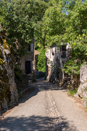 View through a romantic alley in the old medieval village Labeaume in Franceの写真素材