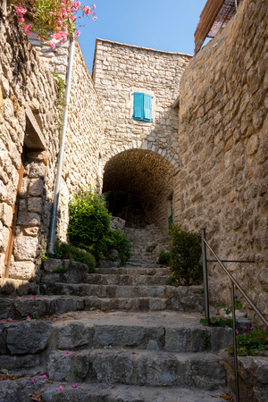 View up the stairs to the cobblestone path through an archway in the old French village Labeaume on the river Ardeche in Franceの写真素材