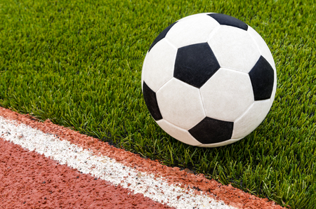 The football is on the artificial grass soccer field in the stadium.の写真素材