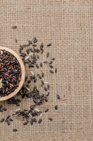 The black rice on the sack bag for background textの写真素材