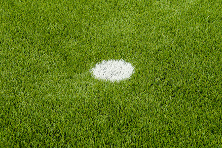 The white penalty point on the artificial green grass soccer field の写真素材