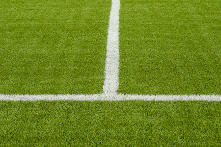 The white Line marking on the artificial green grass soccer field の写真素材