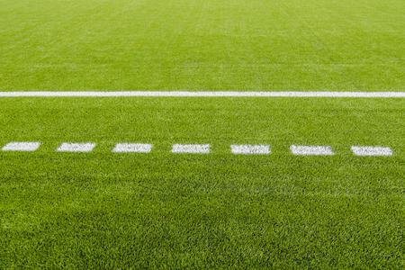 The white Line marking on the artificial green grass soccer field の写真素材
