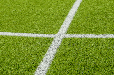 The white Line marking on the artificial green grass soccer field の写真素材