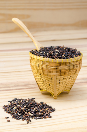 The black rice in the bowl on the tableの写真素材