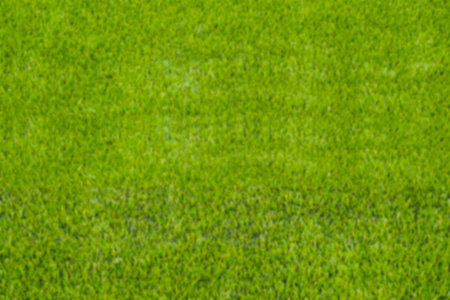The blur of artificial green grass soccer field for backgroud.の写真素材