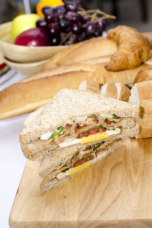 The toast sandwiches served on the chopping board.の写真素材