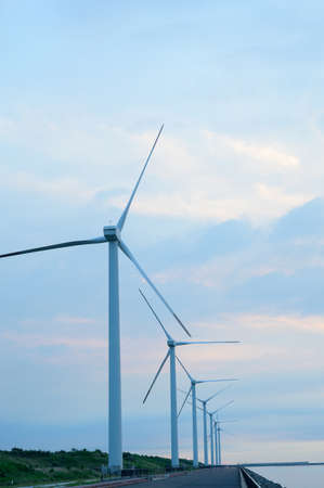 Wind turbine towering in the evening skyの写真素材