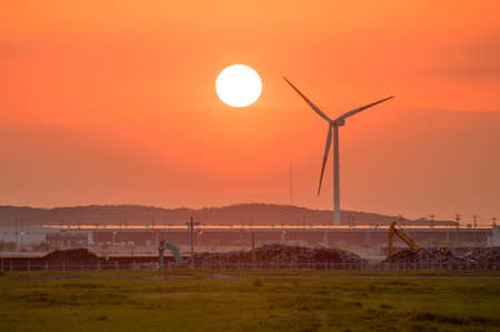 Wind turbine towering in the evening skyの写真素材
