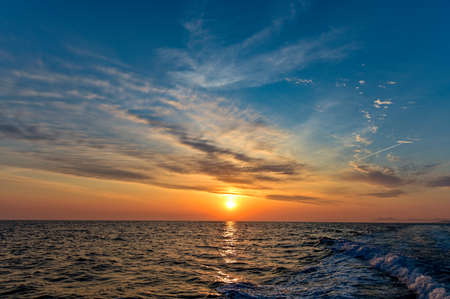 The beautiful orange morning sun rising on the Genkai Seaの写真素材