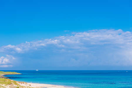 The blue sky, the sea and the coast of the beautiful Kadoshima Ohama beachの写真素材