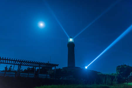 Kadoshima Lighthouse illuminates the sea at nightの写真素材