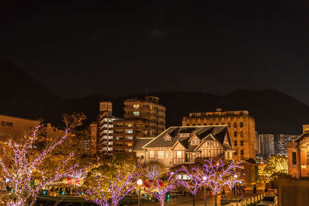 A romantic night view of the building lit up with bright glass lanterns and wooden illuminations at Mojiko Retroの写真素材